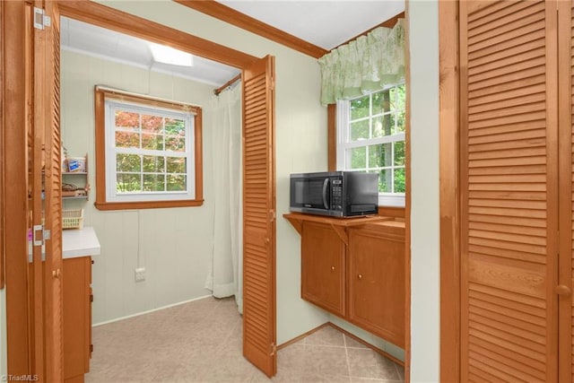 4750 Carlton Dr, Winston-Salem, NC 27105 - hall featuring crown molding, healthy amount of natural light, baseboards, and light tile patterned floors