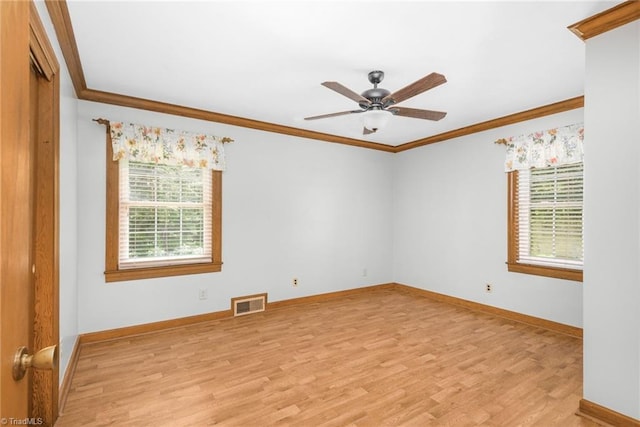 4750 Carlton Dr, Winston-Salem, NC 27105 - spare room featuring plenty of natural light, ornamental molding, light wood-type flooring, ceiling fan, and baseboards