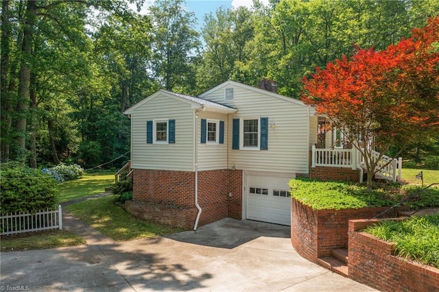4750 Carlton Dr, Winston-Salem, NC 27105 - view of home's exterior with driveway, a garage, stairs, and brick siding