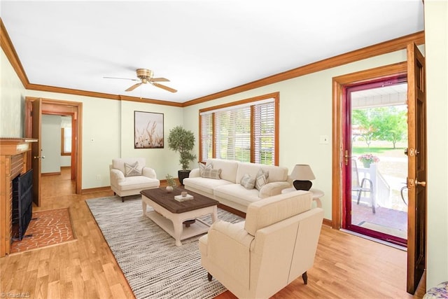 4750 Carlton Dr, Winston-Salem, NC 27105 - living area featuring ornamental molding, light wood-type flooring, a ceiling fan, a brick fireplace, and baseboards