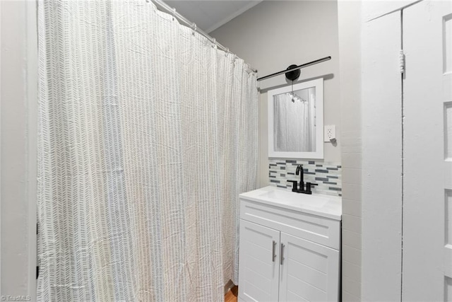 bathroom featuring vanity and decorative backsplash