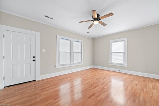 entryway featuring light wood-type flooring, ceiling fan, and crown molding