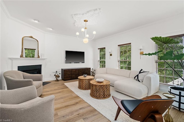 living room featuring ornamental molding, a notable chandelier, and a wealth of natural light