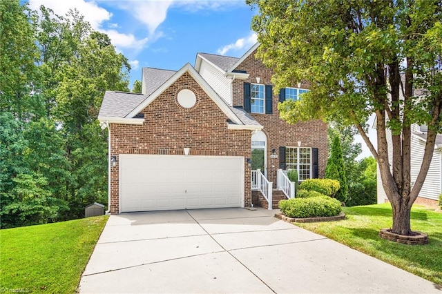 traditional home with concrete driveway, a front yard, and brick siding