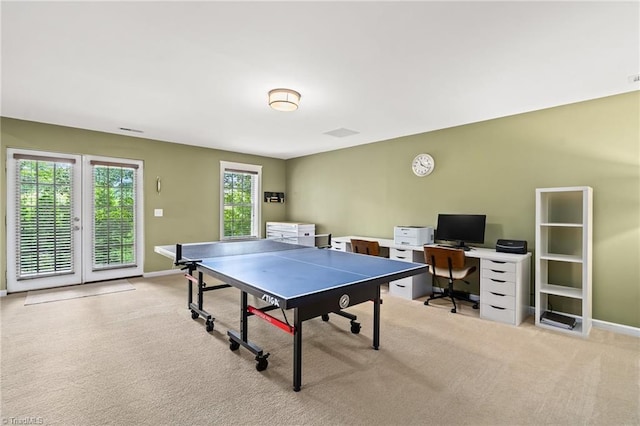 game room with baseboards and light carpet