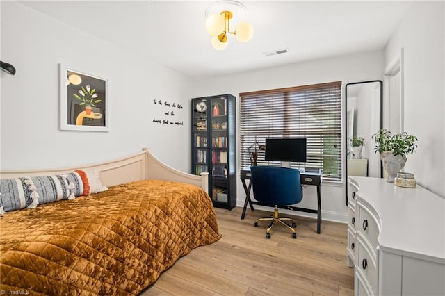 bedroom featuring visible vents and light wood finished floors