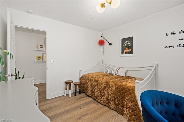 bedroom with baseboards and light wood finished floors