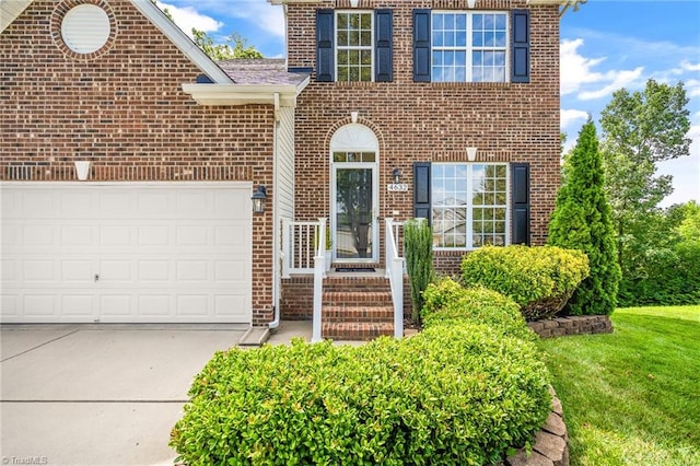exterior space with an attached garage, driveway, and brick siding