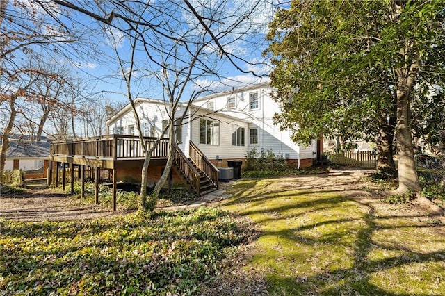 back of property with stairs, a deck, a yard, and cooling unit