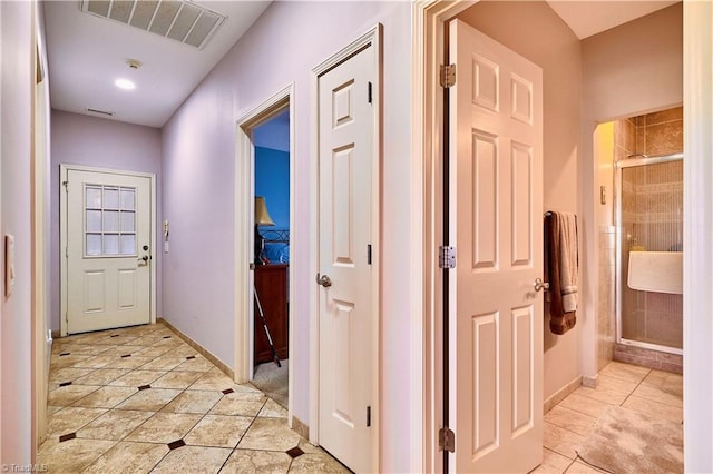 hall with light tile patterned floors