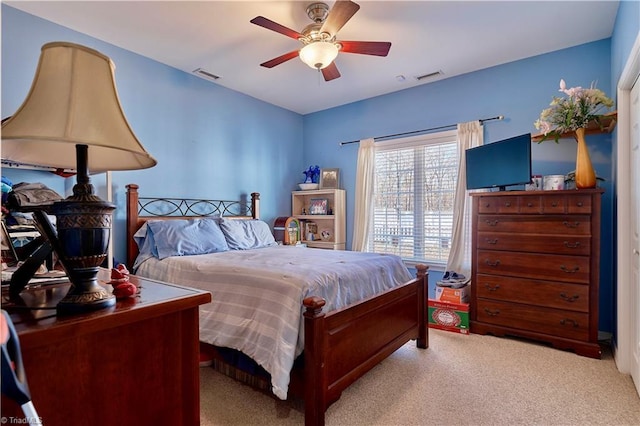 bedroom with ceiling fan and light carpet