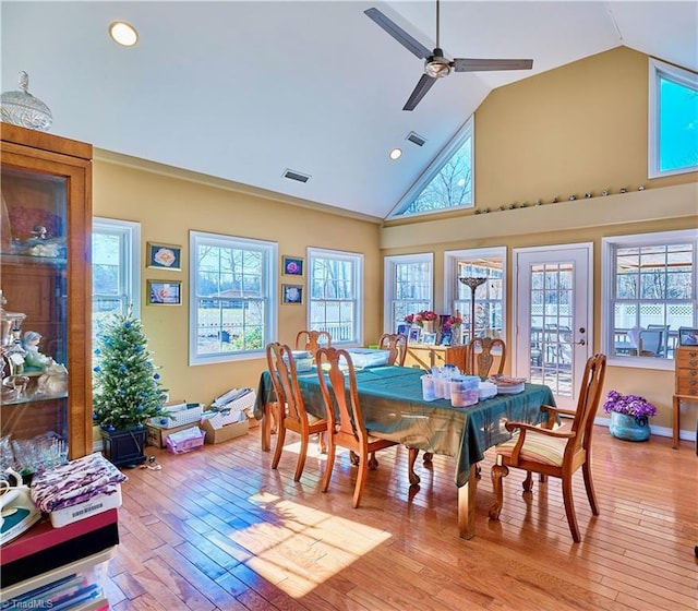 dining room featuring high vaulted ceiling, ceiling fan, and light hardwood / wood-style floors