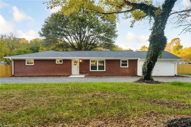 ranch-style home featuring a front yard