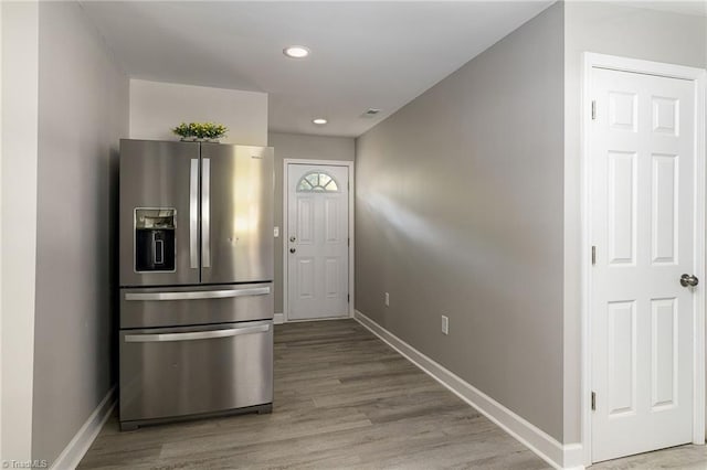 kitchen featuring stainless steel fridge with ice dispenser and light wood-type flooring