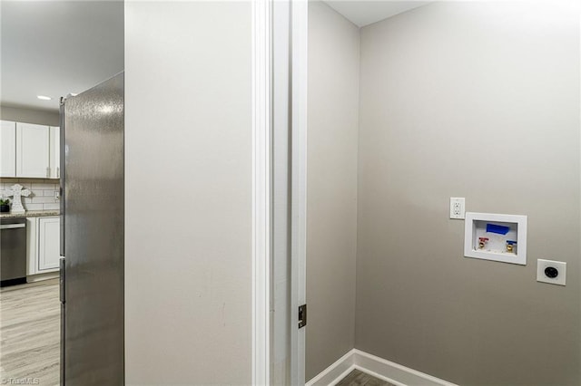 laundry room featuring hookup for an electric dryer, hookup for a washing machine, and light hardwood / wood-style floors