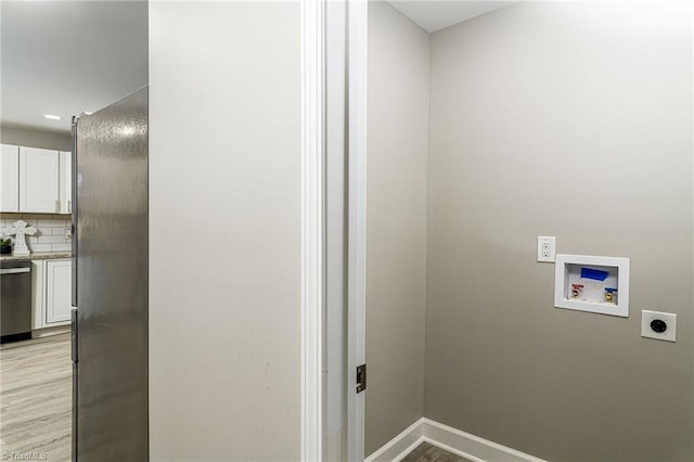 5515 Bethania Rd, Pfafftown, NC 27040 - laundry area featuring hookup for an electric dryer, hookup for a washing machine, light wood-type flooring, and baseboards