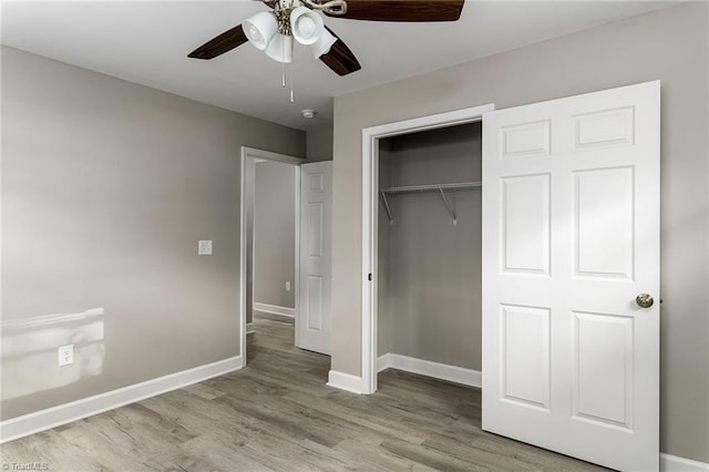 unfurnished bedroom with a closet, light wood-type flooring, and ceiling fan