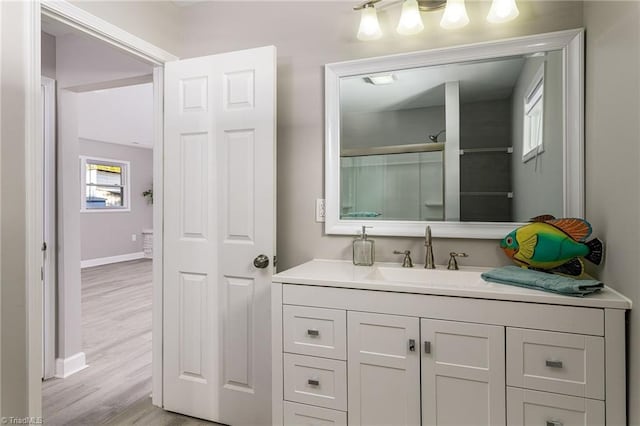 bathroom with vanity, hardwood / wood-style floors, and walk in shower