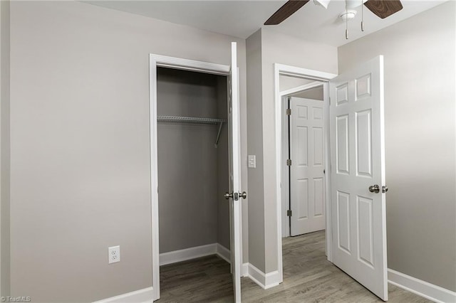 unfurnished bedroom featuring light hardwood / wood-style floors, a closet, and ceiling fan