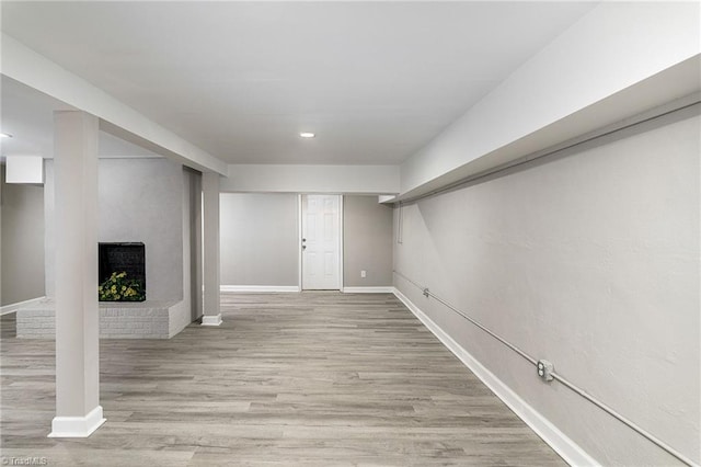 5515 Bethania Rd, Pfafftown, NC 27040 - finished below grade area featuring wood finished floors, a brick fireplace, baseboards, and recessed lighting