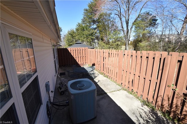 view of patio with a fenced backyard and cooling unit