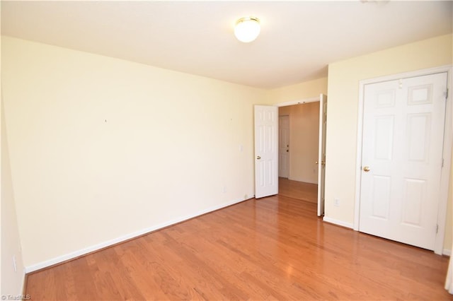 unfurnished bedroom with baseboards and light wood finished floors