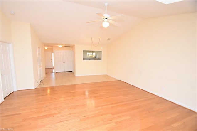 unfurnished room featuring lofted ceiling, light wood finished floors, and ceiling fan