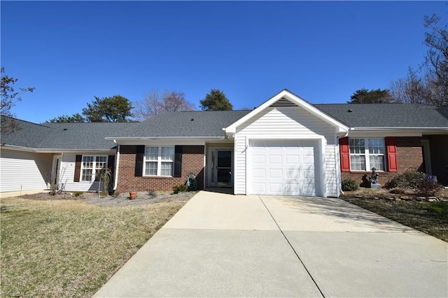 ranch-style house featuring a garage, concrete driveway, brick siding, and a front yard