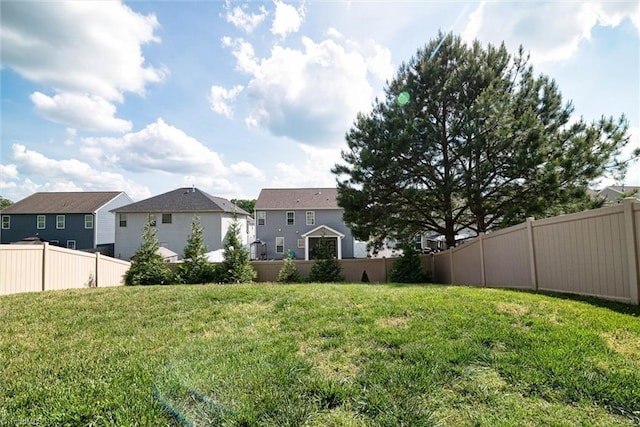 view of yard with a residential view and fence
