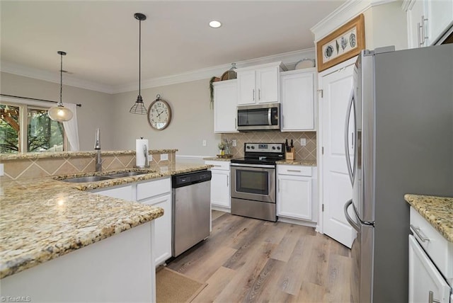 kitchen featuring stainless steel appliances, a sink, light wood-style floors, white cabinetry, and decorative backsplash