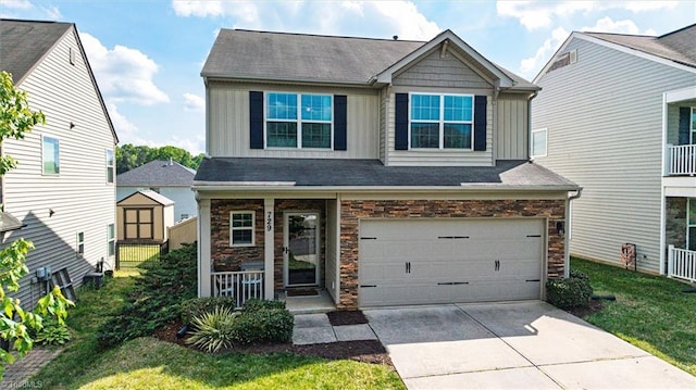 view of front of property featuring board and batten siding, covered porch, driveway, and a garage