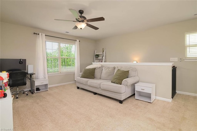 carpeted living room with visible vents, a ceiling fan, and baseboards