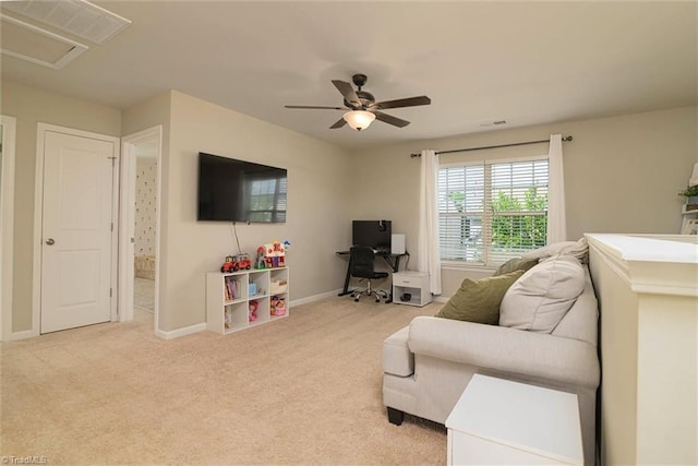 carpeted living area with baseboards, a ceiling fan, and visible vents