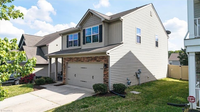 view of side of home featuring a garage, a lawn, fence, and driveway
