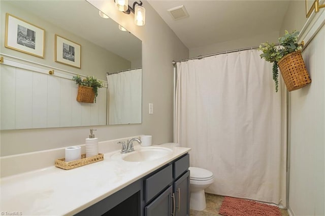 bathroom with visible vents, vanity, and toilet