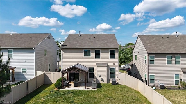 back of property with cooling unit, a lawn, a fenced backyard, and a patio