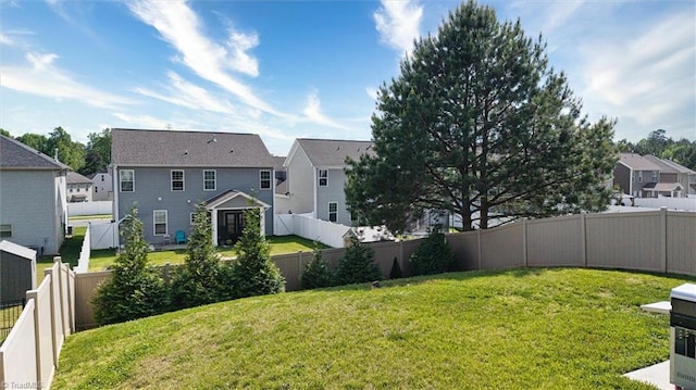 view of yard with a fenced backyard and a residential view