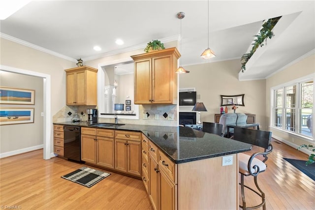 kitchen featuring decorative backsplash, black dishwasher, crown molding, pendant lighting, and light wood-type flooring