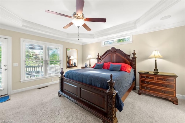 carpeted bedroom with ceiling fan, a raised ceiling, and crown molding