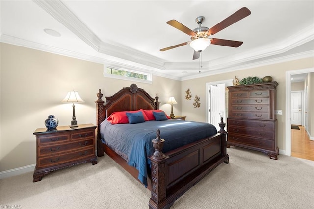 bedroom with crown molding, a tray ceiling, light colored carpet, and ceiling fan