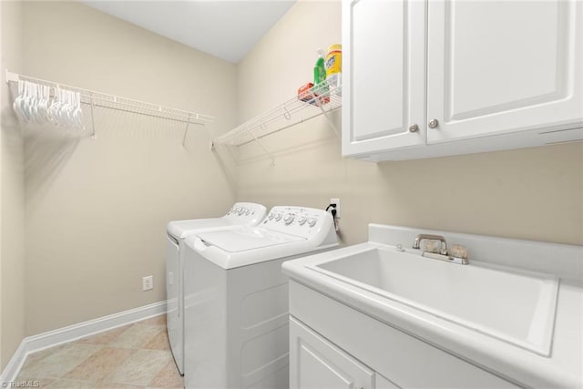 washroom with sink, separate washer and dryer, and cabinets