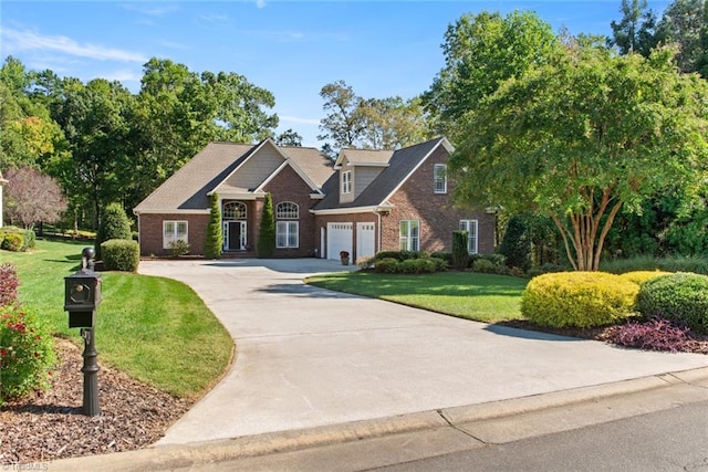 view of front of property with a front yard and a garage