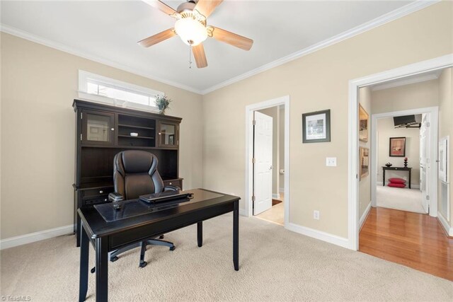 office featuring light carpet, crown molding, and ceiling fan