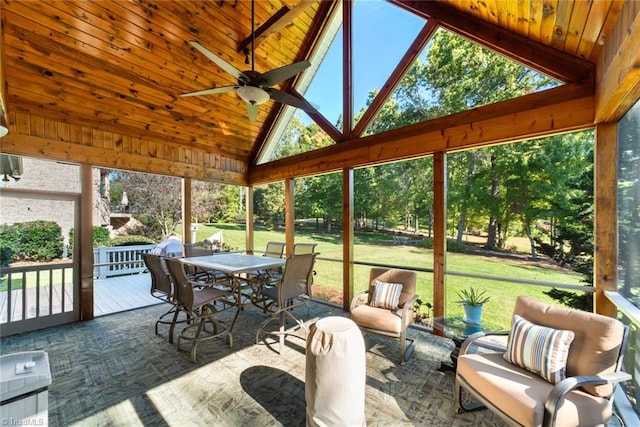 sunroom featuring ceiling fan, wooden ceiling, vaulted ceiling, and a wealth of natural light