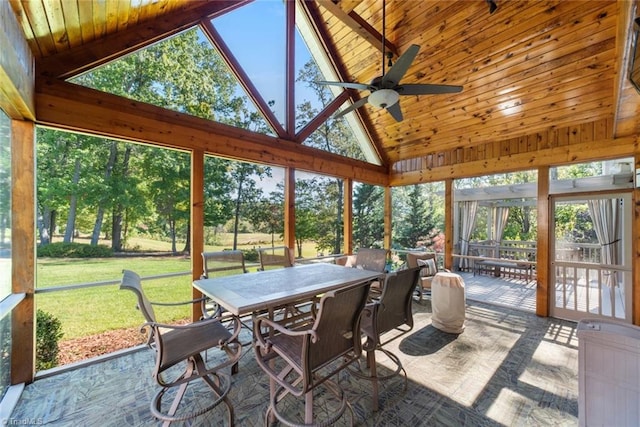 sunroom with ceiling fan, vaulted ceiling, and a wealth of natural light