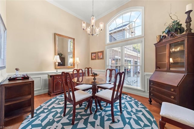 dining room with crown molding, a chandelier, plenty of natural light, and light wood-type flooring