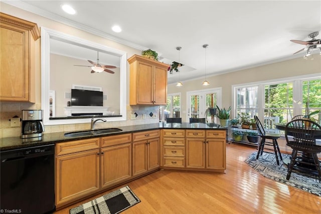 kitchen featuring dishwasher, kitchen peninsula, backsplash, sink, and decorative light fixtures