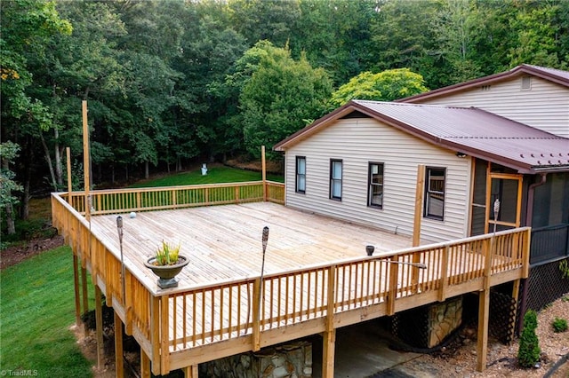 wooden deck featuring a lawn