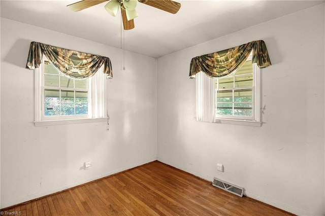 904 Ashe St, Greensboro, NC 27406 - unfurnished room featuring plenty of natural light, ceiling fan, and wood finished floors