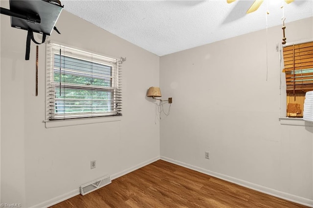 904 Ashe St, Greensboro, NC 27406 - unfurnished room with wood finished floors, ceiling fan, and a textured ceiling